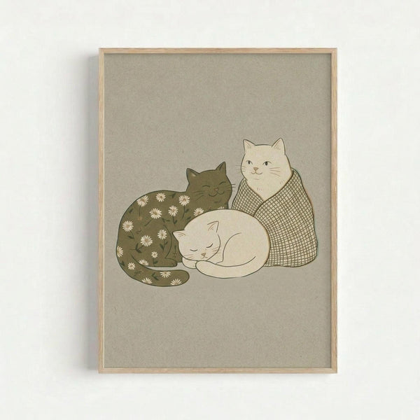 May include: Framed art print hanging on white wall showing three stylized cats in muted earth tones on beige background. One olive green cat with white daisy pattern lies curled up, one cream-colored cat sits upright with crosshatch pattern, and one white cat sleeps in center. Light wood frame surrounds the minimalist illustration with soft, cozy aesthetic.
