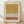 May include: Framed abstract art print leaning against white textured wall on light wood floor. Artwork features earthy ochre watercolor wash at top, black polka dot pattern on cream background in middle, terracotta brown brushstroke band, and smaller dotted section at bottom. Natural wood frame with visible grain. Soft natural lighting creates gentle shadows on wall.