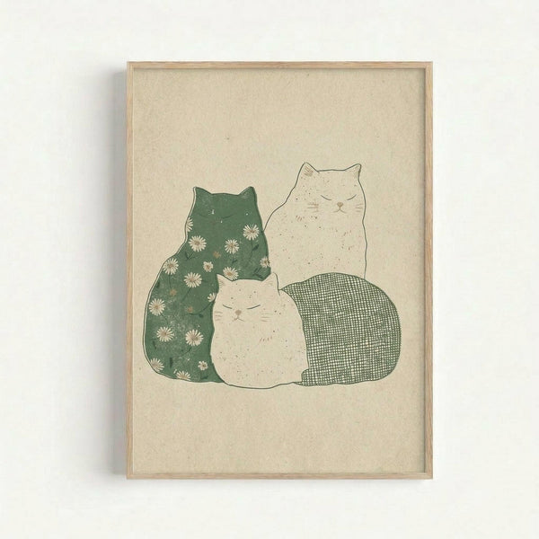 May include: Framed art print on beige textured paper showing three stylized cats in soft, muted tones. One cat features green coloring with small white daisy flowers, another is cream-colored, and the third has a green gingham check pattern. The cats are arranged in a cozy grouping with simple line art style. Light wood frame against white wall.