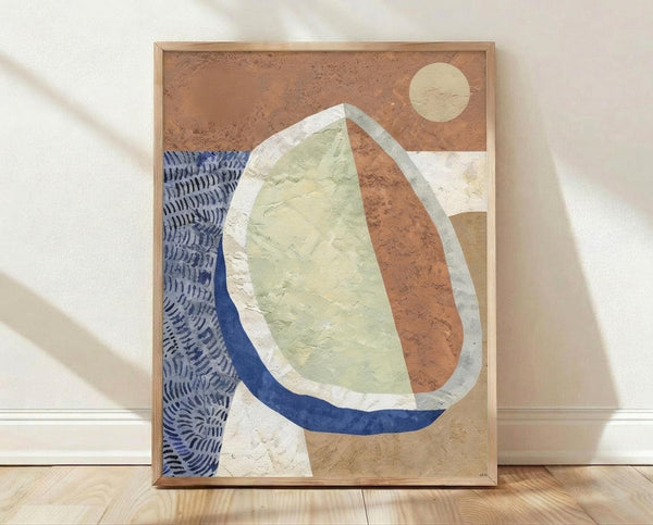 May include: Framed abstract artwork leaning against white wall on light wooden floor. The poster features organic curved shapes in terracotta orange, sage green, and navy blue with white outlines, plus a pale yellow circular moon shape in upper right corner. Blue patterned texture appears on left side. Natural wood frame surrounds the composition. Soft natural lighting creates gentle shadows on the white textured wall.