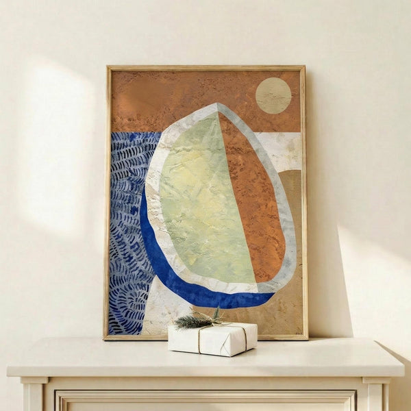 May include: Abstract artwork in wooden frame leaning against white wall on light wood surface, featuring organic curved shapes in terracotta orange, sage green, and navy blue with textured brushstrokes and small cream circle, displayed next to white wrapped gift with evergreen sprig
