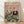 May include: Framed vintage-style poster showing two elegant ducks in formal attire at a dinner table. The female duck wears a beaded evening gown with feather boa, while the male sports a burgundy tuxedo with bow tie and monocle. They're seated at a green tablecloth-covered table laden with fine dining elements including champagne flutes, candelabras, plates of gourmet food, and silverware. The illustration has a whimsical anthropomorphic style with "FANCY DUCKS" text at the top in colorful l