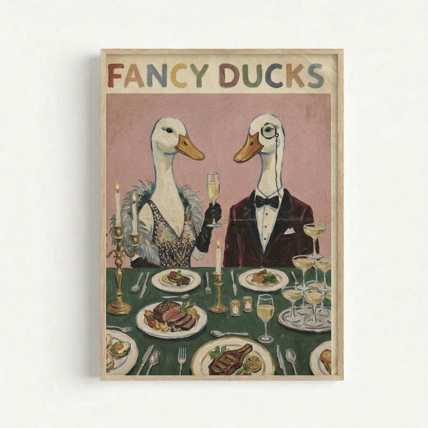 Whimsical vintage-style illustration of two elegant ducks dressed in formal attire seated at a dinner table. The left duck wears a sparkly black dress with feathers, while the right duck sports a burgundy tuxedo with bow tie and monocle. They're dining at a green tablecloth-covered table set with fine china plates of food, champagne flutes, candelabras, and silverware against a soft pink background. The artwork is displayed in a light wooden frame with colorful "FANCY DUCKS" lettering at the t