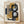 May include: Abstract geometric artwork in light wood frame leaning against white wall on wooden floor. Features overlapping shapes in mustard yellow, navy blue, gray, and black with bold curved black lines creating dynamic composition. Print has cream background with visible texture and appears to be numbered edition with artist signature.