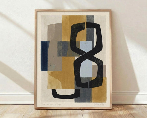 May include: Abstract geometric artwork in light wood frame leaning against white wall on wooden floor. Features overlapping shapes in mustard yellow, navy blue, gray, and black with bold curved black lines creating dynamic composition. Print has cream background with visible texture and appears to be numbered edition with artist signature.