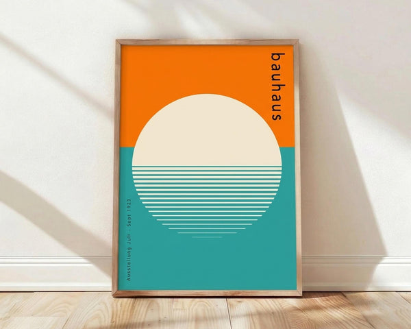 May include: Framed minimalist poster with orange and teal color blocks featuring a large cream circle with horizontal line details, displayed against white walls on light wooden flooring in natural lighting with soft shadows