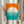 May include: Person holding framed geometric art print featuring large white circle on orange and teal background with horizontal line pattern. Modern minimalist design in thin light wood frame. Dried pampas grass visible to left, neutral beige clothing and white curtained background create warm, contemporary home setting.