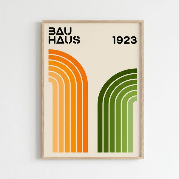 May include: Framed geometric poster with cream background featuring two curved rainbow arches - one orange gradient on left, one green gradient on right. Bold black text reads "BAUHAUS" and "1923" at top. Modern minimalist design in light wood frame hanging on white wall.