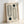 May include: Minimalist geometric art print in light wooden frame leaning against white wall. Design features black concentric oval and rounded rectangular shapes with two dark green circles on cream background. Text reads "BAUHAUS 1923" vertically along right side. Modern Bauhaus-inspired typography and clean lines create mid-century aesthetic.