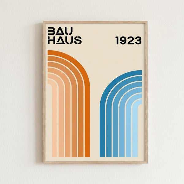 May include: Framed poster with cream background displaying "BAUHAUS 1923" in bold black letters at top. Two sets of curved parallel lines create rainbow-like arches - orange gradient stripes on left transitioning from deep orange to pale peach, blue gradient stripes on right fading from dark blue to light blue. Simple wooden frame against white wall.