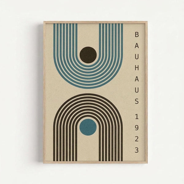 Framed geometric art print featuring two stylized arches in mid-century modern style. Top arch has teal blue concentric lines with black center circle. Bottom arch displays black and white stripes with small teal circle. Text reading "BAUHAUS 1923" appears vertically on cream background. Light wood frame against white wall.
