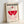 May include: Framed poster with geometric Bauhaus design featuring red semicircle, pink striped elements, and red striped circle on cream background. Light wood frame leaning against white wall, showing modern minimalist exhibition poster artwork in pink and red color palette.