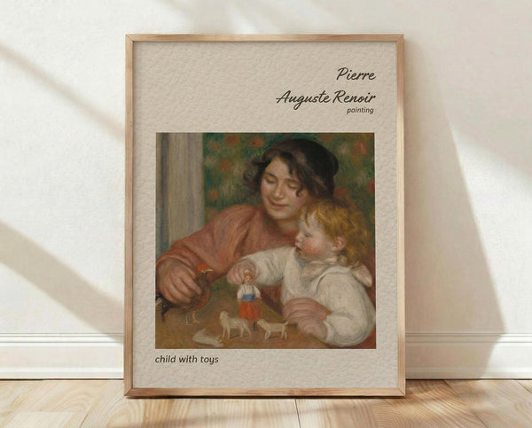 May include: Framed art print showing Renoir's impressionist painting of a woman in rust-colored clothing holding a blonde child in white, with small toy figures visible. The print has beige matting in a light wood frame, leaning against a white textured wall on light wooden flooring with soft natural lighting and shadows.