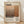 May include: Framed poster print featuring Mark Rothko's name in large black serif letters, abstract landscape painting in warm brown and orange tones, biographical text about the artist, and birth-death years 1903-1970. Light wood frame rests against white textured wall on wooden floor with soft natural lighting casting shadows.