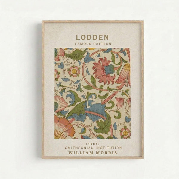 May include: Framed botanical art print displayed on white wall. Features William Morris's ornate floral pattern with flowing vines, stylized flowers and leaves in coral pink, sage green, dusty blue and cream colors. Light wood frame surrounds cream matting with vintage-style typography. Decorative Arts and Crafts movement design with intricate curving stems and blooms.