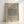 May include: Framed botanical poster with sage green textured pattern sample, cream background, vintage-inspired typography reading "William Morris Cotton Eye Bright Famous Pattern 1882", displayed in light wood frame against white wall with soft natural lighting