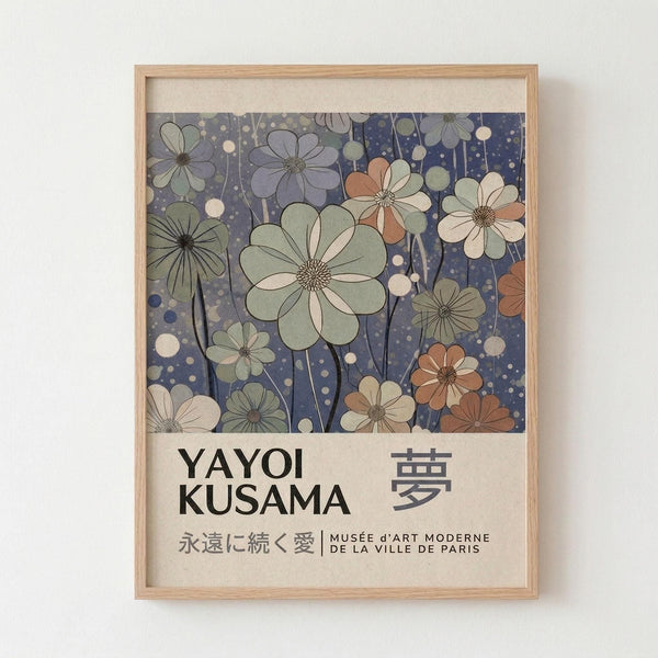 May include: Framed art print displayed on white wall featuring stylized flowers in muted green, purple, coral and cream tones against dark blue background with scattered dots. Text below reads "YAYOI KUSAMA" with Japanese characters and "永遠に続く愛 | MUSÉE d'ART MODERNE DE LA VILLE DE PARIS". Light wood frame with white matting on textured wall.