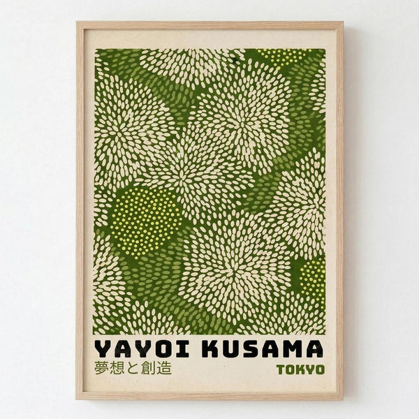 May include: Framed art print with green abstract pattern featuring radiating dotted bursts resembling flowers or fireworks in various shades of green and cream. Bold black text reads "YAYOI KUSAMA" with Japanese characters and "TOKYO" below. Light wood frame with white mat, displayed against white wall. Organic flowing design with repetitive circular motifs creates dynamic visual movement across the composition.