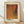 May include: Framed art print leaning against white wall on wooden floor. Poster features abstract composition with flowing orange, burgundy, and teal curved shapes on dotted textured background. Japanese text at top, artist name at bottom. Light wooden frame with cream matting. Natural lighting creates soft shadows on wall.