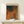 May include: Abstract art poster in wooden frame featuring layered curved forms in warm earth tones - oranges, browns, and russets - with dark green accent at top. Dotted mesh texture throughout creates depth and movement. Displayed on light wood console with small wrapped gift beside it. Japanese text visible on right side of print.