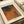 May include: Abstract art print with overlapping circular forms in warm orange, brown, and green tones against textured background. White matted frame lies on neutral surface next to rolled paper tube. Japanese characters visible in corner. Dotted halftone pattern creates depth and movement throughout the geometric composition.