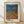 May include: Framed poster print featuring abstract wavy forms in blue and orange gradient with dotted halftone pattern texture, displayed in light wooden frame against white wall on wooden floor. Japanese text visible at top, artist name at bottom on cream background.