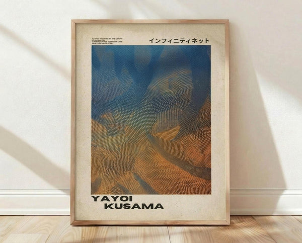 May include: Framed poster print featuring abstract wavy forms in blue and orange gradient with dotted halftone pattern texture, displayed in light wooden frame against white wall on wooden floor. Japanese text visible at top, artist name at bottom on cream background.