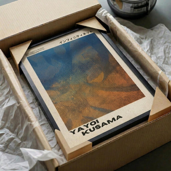 May include: Framed art print with abstract dotted pattern in blue and orange tones, displayed in black frame on cream mat. Print shows halftone dot texture creating flowing, wave-like forms. Arranged in cardboard shipping box with protective tissue paper and wooden dowels for safe packaging.