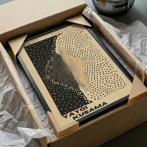 May include: Framed art print featuring a dotted halftone portrait in black and cream tones, displayed in wooden box packaging with protective wrapping. The artwork shows a face rendered in varying sized dots that create depth and shadow, with "YAYOI KUSAMA" text at bottom. Frame appears dark colored, surrounded by tissue paper and cardboard shipping materials.