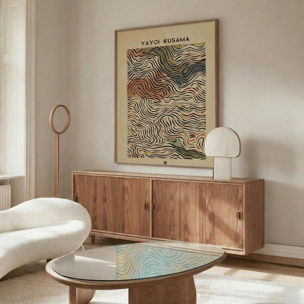 May include: Framed poster with flowing wavy lines in earth tones and colorful swirls, displayed above a mid-century modern walnut credenza in a bright living room with white curved chair, round glass coffee table, and minimalist decor