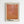May include: Framed art print displayed on white wall featuring abstract orange and coral colored organic shapes with dotted texture patterns. Text at top reads "INFINITI NET" in Japanese characters, with "YAYOI KUSAMA" in bold black letters at bottom. Natural wood frame with white matting against minimalist interior setting.