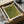 May include: Green textured art print with dotted pattern displayed in light wood frame, packaged in brown cardboard box with tissue paper. Wooden dowels visible alongside the framed artwork. The print features an olive-green surface with subtle circular dot textures and Japanese characters in the corner.