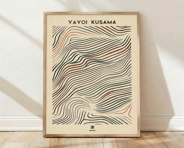 May include: Framed poster print featuring flowing wavy lines in black, terracotta, and sage green colors on cream textured paper background. The abstract wave pattern creates an organic, undulating design. Text reads "YAYOI KUSAMA" at top and Japanese character with "waves" at bottom. Light wood frame sits on wooden floor against white wall with soft natural lighting and shadows.