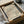 May include: Framed art print with flowing black and coral pink wavy lines creating an abstract topographical pattern, displayed in black frame inside cardboard packaging box with tissue paper and wooden dowels for protection