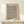 May include: Framed poster with black polka dot pattern on white background, Japanese text at top, displayed on light wood shelf against beige wall. Small wrapped gift box with greenery sprig sits in front of wooden frame. Minimalist Scandinavian-style home decor setting with neutral tones and clean lines.