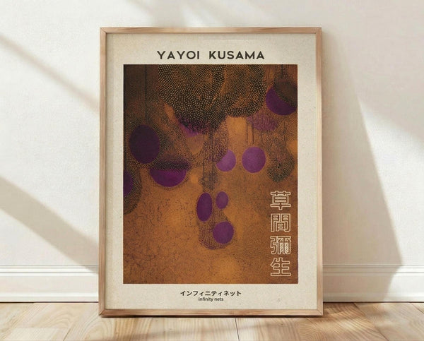May include: Framed art print displayed on wooden floor against white wall with natural lighting. The artwork features an abstract composition with purple circular dots scattered across a textured orange-brown background with dotted patterns. Light wooden frame with cream matting. Japanese characters visible on right side of print along with "infinity nets" text at bottom.