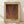 May include: Framed art poster with abstract orange and burgundy textured pattern resembling organic cellular forms or dotted waves. Light wood frame with cream matting, leaning against white wall on light wooden floor with natural window shadows cast across the scene.