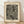 May include: Framed art print with cream background featuring black and white abstract pattern of flowing wavy lines and polka dots. Text reads "YAYOI KUSAMA" at top and Japanese characters with "dots obsession" below the artwork. Natural wood frame sits on light wooden floor against white wall with soft shadows.