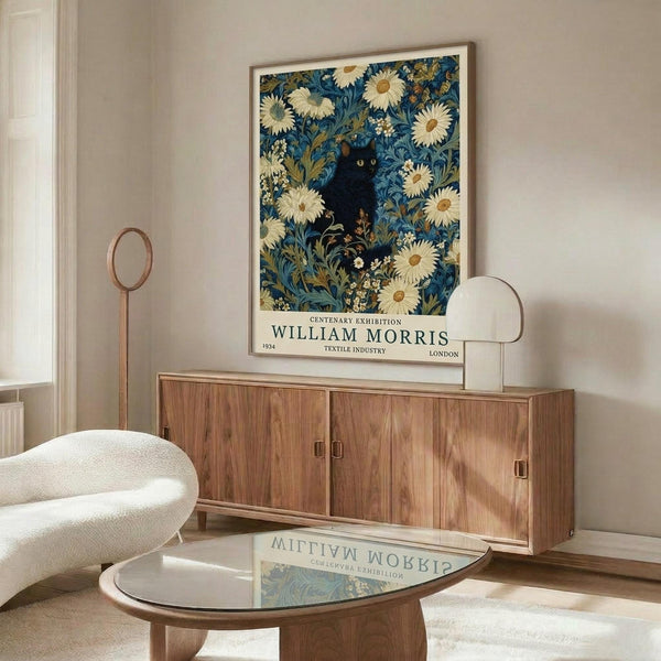 May include: Framed vintage-style poster featuring a black cat among blue and cream floral William Morris-inspired textile pattern, displayed above a walnut wood credenza in a modern living room with white curved chair, glass coffee table, and floor lamp