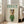 May include: Framed poster featuring a white dog wearing dark sunglasses, colorful patterned headscarf, and green knit sweater against cream background with "DOGUE" text in teal letters at top, displayed on wooden floor next to beige upholstered chair in bright room with white walls and windows