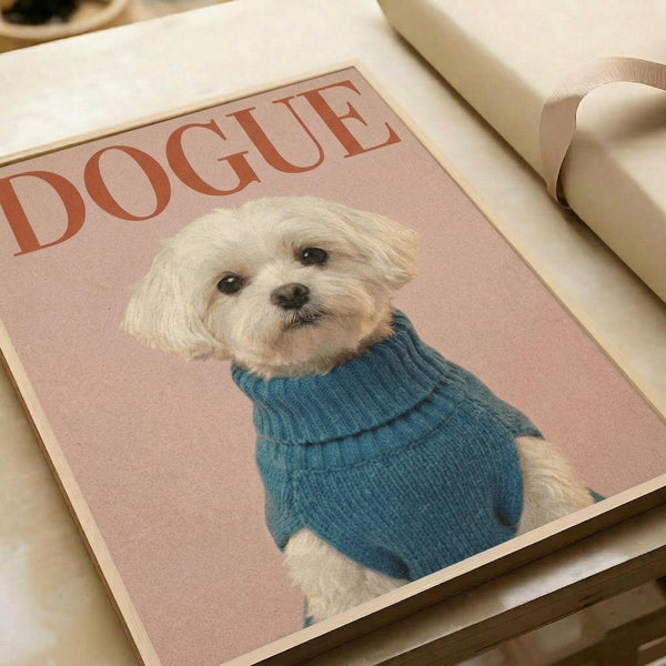 May include: Pink magazine-style poster featuring a small white fluffy dog wearing a blue knit turtleneck sweater, with "DOGUE" text in red letters at top, displayed on white bedding next to a beige pillow in soft natural lighting