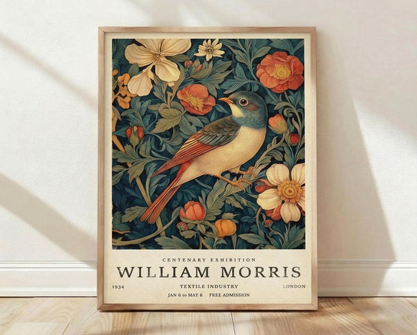 May include: Framed vintage exhibition poster featuring colorful bird with orange tail perched among botanical florals in deep teal, coral, and cream tones. Natural wood frame displayed on light wooden floor against white textured wall with soft shadows.