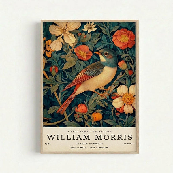 A vintage exhibition poster featuring a colorful bird with orange and cream plumage perched among decorative flowers and foliage in rich greens, corals, and golden yellows. The ornate botanical pattern surrounds the bird in an Arts and Crafts style design against a dark background. Below the artwork, white text reads "Centenary Exhibition William Morris" with "1934", "Textile Industry", "London", and exhibition dates. The poster is displayed in a light wooden frame ag
