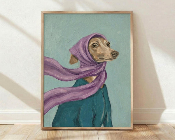 May include: Framed painting of a tan Italian Greyhound wearing a purple headscarf and teal coat against a sage green background, displayed in a light wood frame leaning against white walls on wooden flooring with soft natural lighting creating diagonal shadows