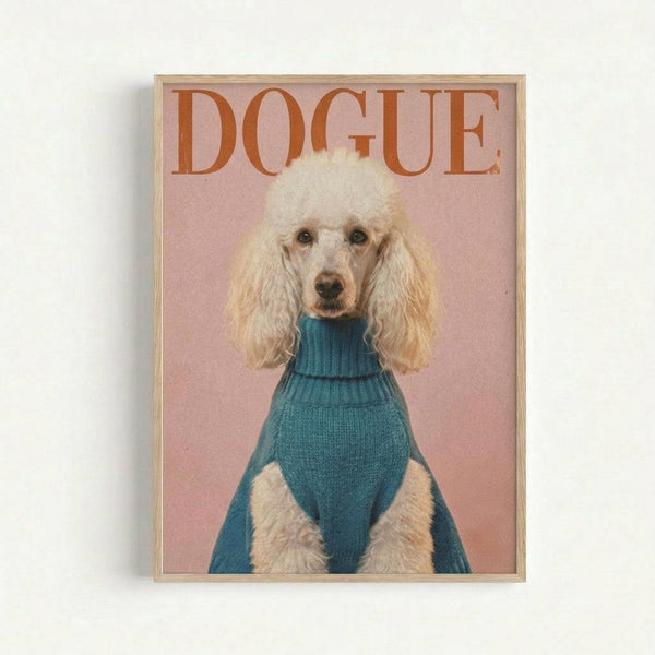 A framed poster featuring a white poodle with fluffy, curly fur wearing a teal blue turtleneck sweater against a soft pink background. The word "DOGUE" appears in large orange serif letters at the top, mimicking a fashion magazine cover style. The poodle sits upright looking directly forward with a serious expression. The artwork is displayed in a thin light wood frame against a white wall.