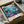 May include: Vibrant underwater scene poster in black frame, packed in cardboard shipping box with protective tissue paper. Artwork features colorful fish, coral, and sea life in blues, purples, oranges and greens. Text shows "JAPAN 1984" and "MUSÉE D'ART MODERNE DE LA VILLE DE PARIS" at bottom. Vintage exhibition poster style with dreamy aquatic illustration containing tropical fish and marine plants against deep ocean backdrop.
