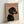 May include: Framed poster print featuring a black and tan dachshund in profile wearing a rhinestone collar against a dusty pink background, with "DOGUE" text in orange letters at the top, displayed in a light wooden frame leaning against a white wall