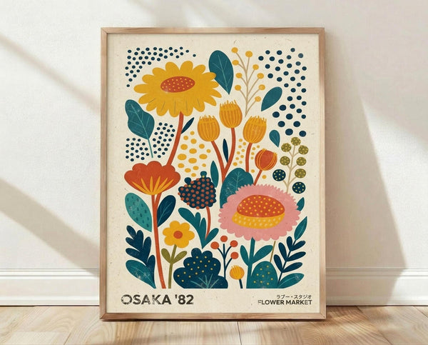 May include: Framed botanical poster print featuring stylized flowers in retro mid-century modern design with yellow sunflower, pink bloom, orange tulips, and teal leaves against cream background with colorful dotted patterns, displayed in natural wood frame leaning against white wall on light wooden floor