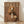 May include: Framed poster print leaning against white wall on wooden floor. Brown-toned fashion magazine cover featuring a spaniel dog wearing a tan blazer with orchid boutonniere. The dog has wavy reddish-brown and white fur with long ears. Large "DOGUE" text at top in cream letters on rich brown background. Warm, sophisticated styling with monochromatic color palette.