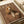 May include: Fashion magazine cover featuring a cocker spaniel wearing a tan blazer with a small orchid accent, displayed on neutral-toned paper with cream ribbon nearby. The cover has "DOGUE" text in large letters across the top in warm brown tones, styled like a luxury fashion magazine.
